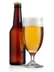 Full brown beer bottle with a glass