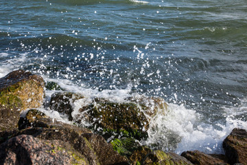 Waves breaking onto a stony seashore.