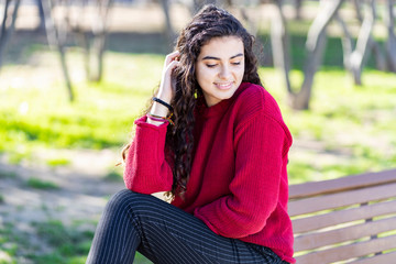 Cute young woman sitting on bench park