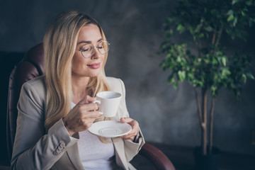 Photo of charming sweet cute nice pretty ceo enjoying cup of coffee in spectacles having rest after consulting her workers about developing new project