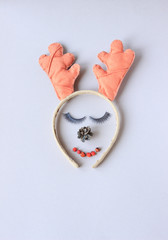 deer horns, on the rim, lie on a gray background, Christmas concept, deer muzzle, Santa Claus helper