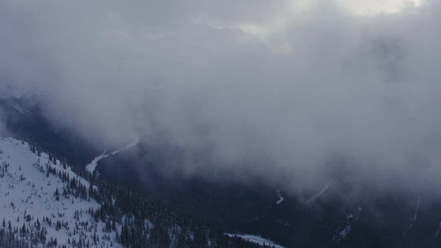 Stunning Day to Night Timelapse Winter Mountain Valley Clouds Covering View of Mt Rainier and Frozen Nisqually River Cascade Mountain Range Washington USA