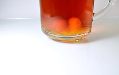 pieces of sugar at the bottom of a transparent cup with tea