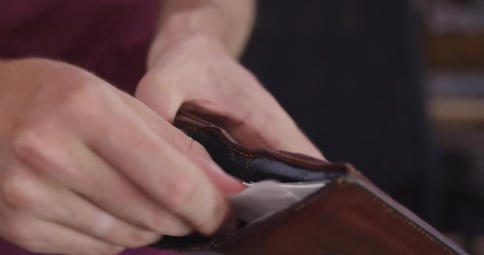 Close Up - A wallet is opened and only receipts are inside to be gone through - shot on RED