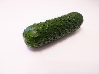 Textured green cucumber on white background