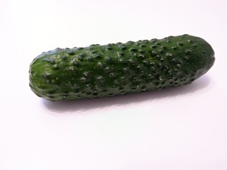 Textured green cucumber on white background