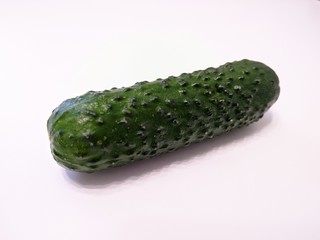 Textured green cucumber on white background