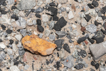 The background of black and orange stones on beach lacked a small, neatly arranged on the ground.