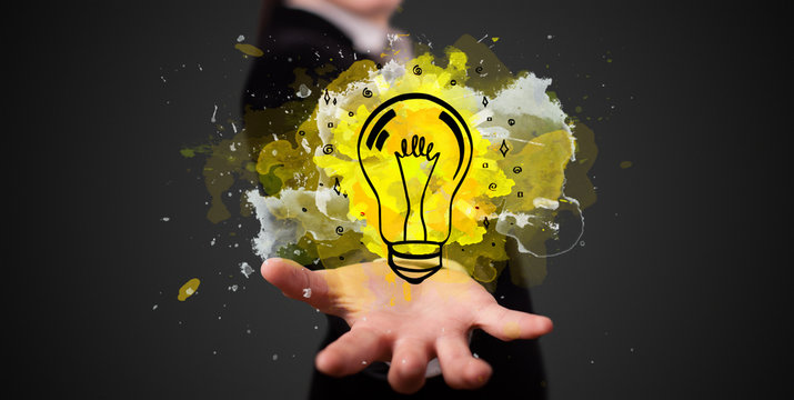 Elegant hand holding lighting bulb in his hand, new idea concept