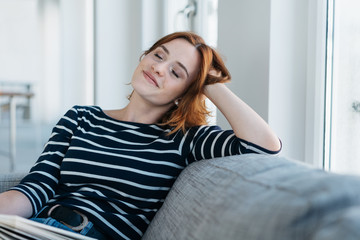Pretty young woman relaxing with closed eyes