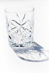 Vintage empty whiskey glass on white background.