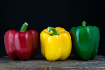 The sweet pepper, bell pepper Red Green Yellow on black background