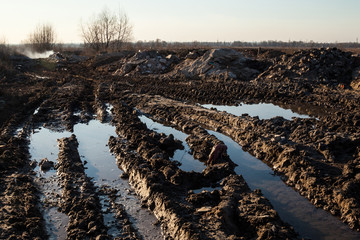 Mud and puddles on the dirt road