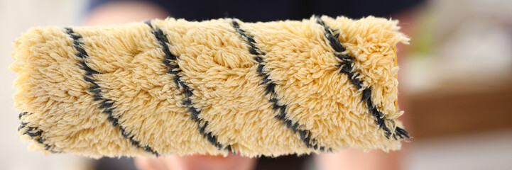 Arm of smiling worker hold brush closeup