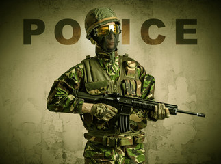 Uniformed armed soldier with damaged wall background