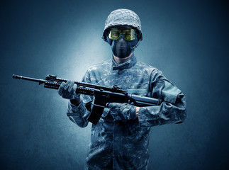 Soldier agent in a dark room with arms on his hand and gas mask