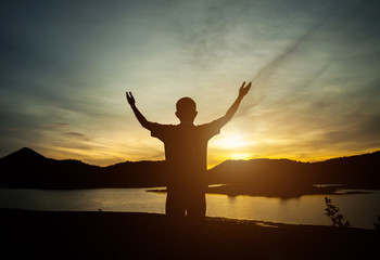 Fototapeta premium Silhouette of man the happy. Natural light, Golden evening light, last light.