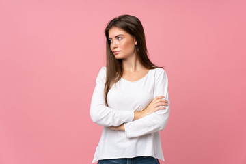 Fototapeta premium Young woman over isolated pink background portrait