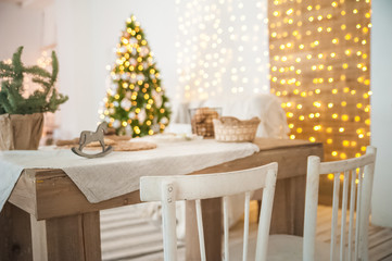 Details of the decorated New Year's interior. Scandinavian living room and kitchen for Christmas. The comfort of homely rustic decor.