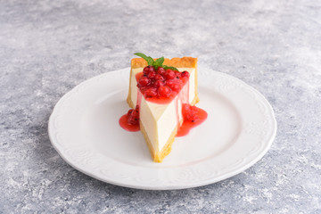 Modern cheese cake and red currant beeries