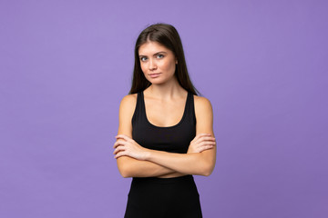 Young girl woman over isolated background keeping the arms crossed