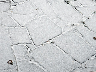 red stone paved with snow road and brick wall