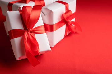 Christmas gift with red ribbon on the red background. Christmas and New Year background.