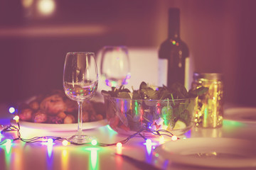 Toned photo of romantic supper for pair in New year eve.