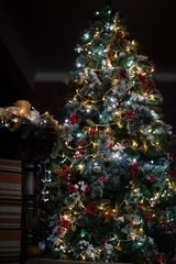 Decorated for the new year interior of the house-the General plan. Christmas tree and decorated Studio, lights garlands, decorations, gift boxes in a cozy home.