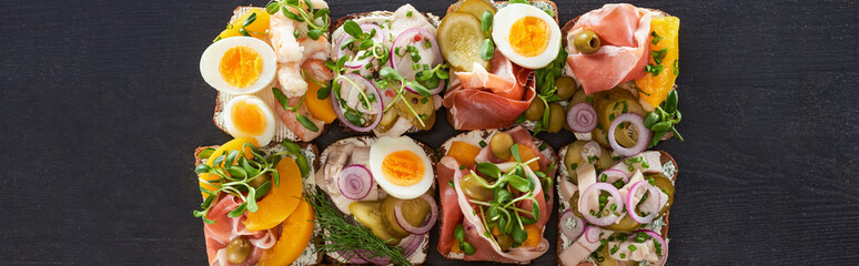 panoramic shot of prepared smorrebrod sandwiches on grey surface