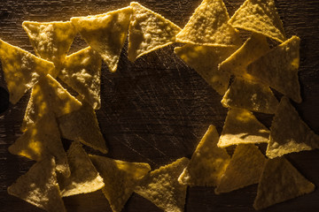 top view of delicious crispy corn nachos arranged in frame on wooden rustic table with copy space