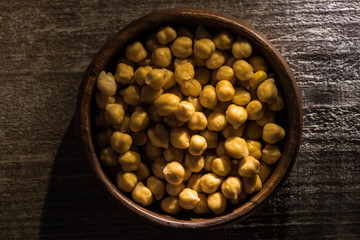 top view of chickpeas in bowl on wooden rustic table
