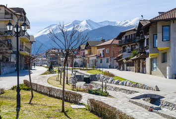 Gotse Delchev street and promenade in the mountain town of Bansko, now the largest mountain resort in Bulgaria. In the background the Pirin mountains
