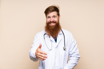 Redhead man with long beard over isolated background with doctor gown and making a deal