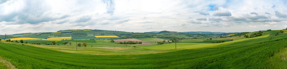 Obraz premium Day natural videangle view at German pastures and cornfields under blue cloudy skies spring time 36 mp stitched panorama