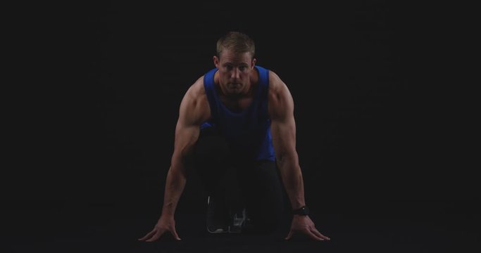 Male runner on starting blocks