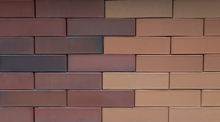 A fragment of a two-tone brick wall, the seam runs in the middle of the wall. Modern brick, thin seams.