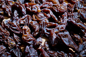 Dried healthy grapes photographed on a wooden surface close-up.