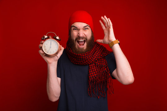 Photo of bearded guy in red hat and scarf, worried and screaming about deadline