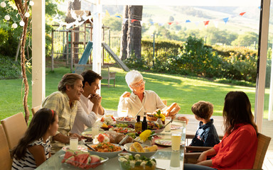 Naklejka premium Family eating outside together in summer