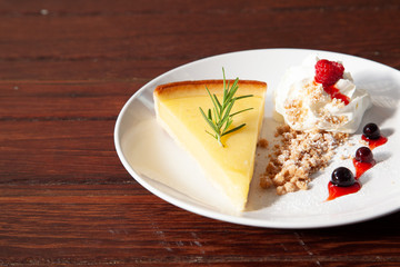 Fresh tasty lemon tart with crumble and whipped cream