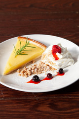 Fresh tasty lemon tart with crumble and whipped cream