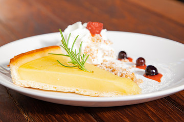 Fresh tasty lemon tart with crumble and whipped cream