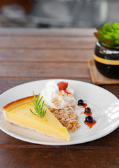 Fresh tasty lemon tart with crumble and whipped cream