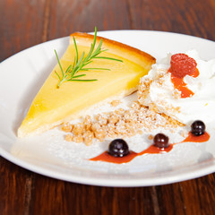 Fresh tasty lemon tart with crumble and whipped cream