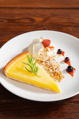Fresh tasty lemon tart with crumble and whipped cream