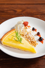 Fresh tasty lemon tart with crumble and whipped cream