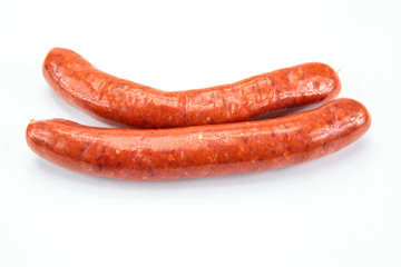 several raw merguez on a white background