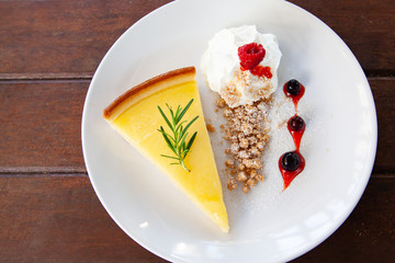 Fresh tasty lemon tart with crumble and whipped cream