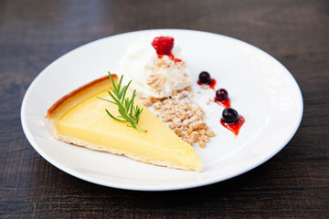 Fresh tasty lemon tart with crumble and whipped cream